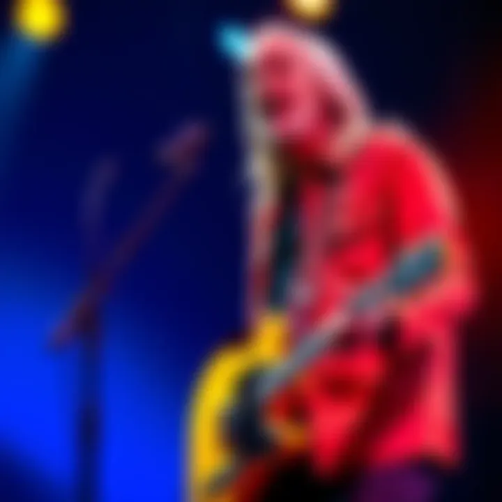 Tom Petty on stage with guitar, singing into the microphone during a concert.
